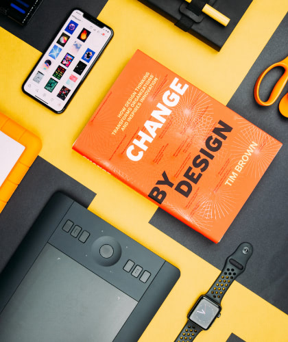 Design book, phone, and smartwatch on a desk